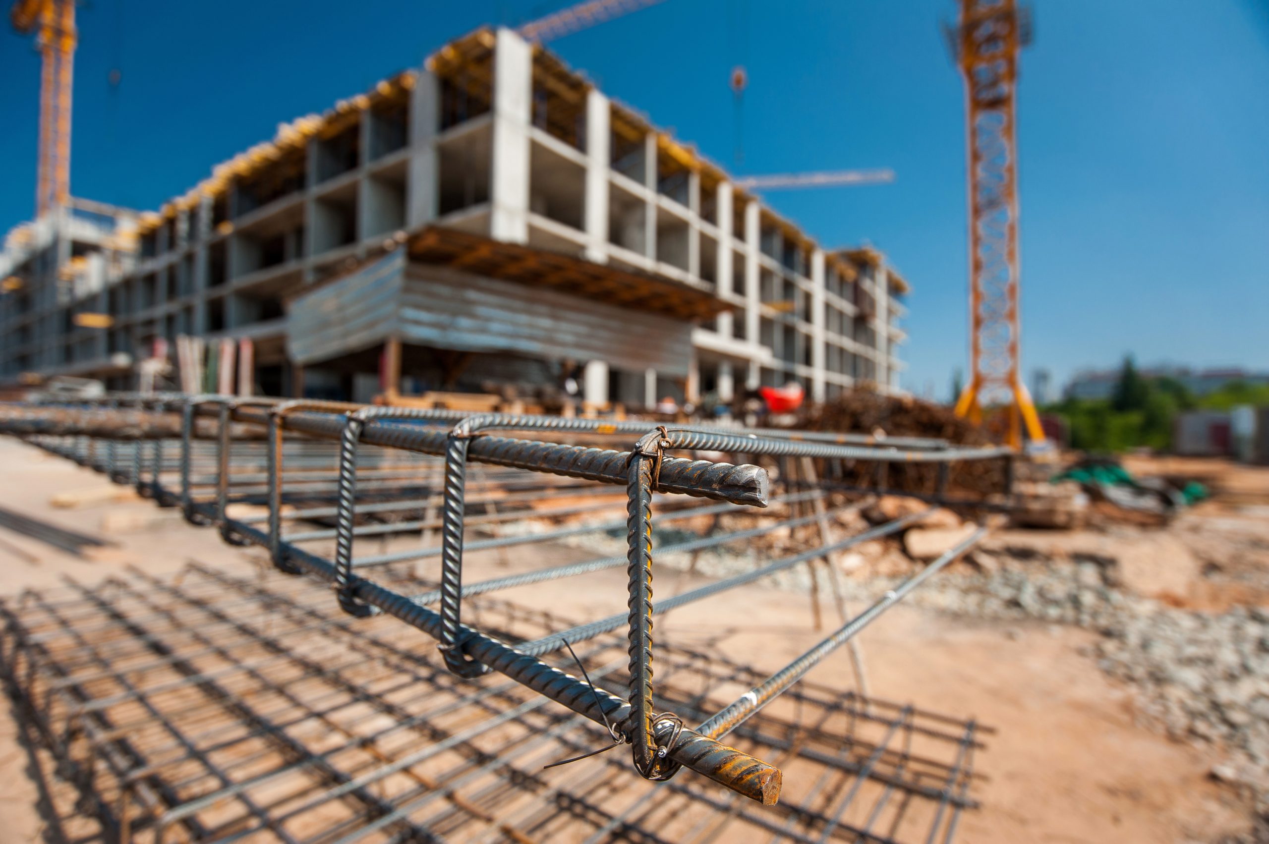 metal-frame-construction-site-with-blurry-plan